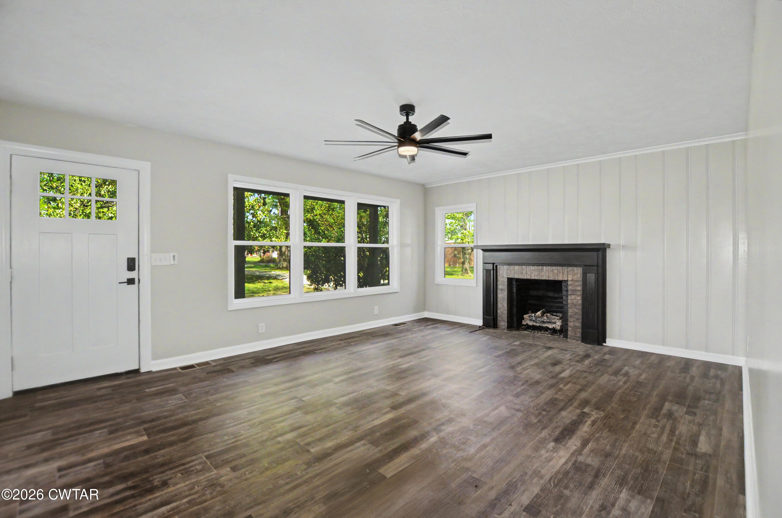 4177 Gum Flat Road Bells, TN 38006 - Photo 13 of 30 an empty room with windows a fireplace and a fireplace