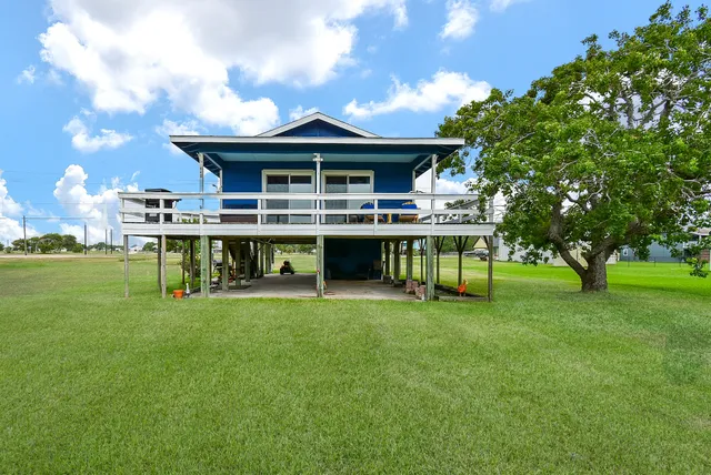 a view of a house with a backyard porch and sitting area