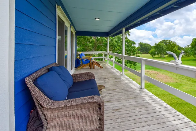 a view of roof deck with couches and wooden floor