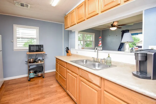 a kitchen with sink cabinets and window
