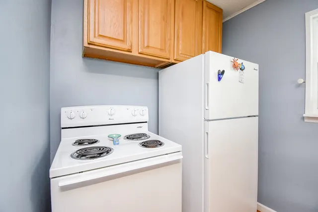 a white refrigerator freezer sitting next to a white wall