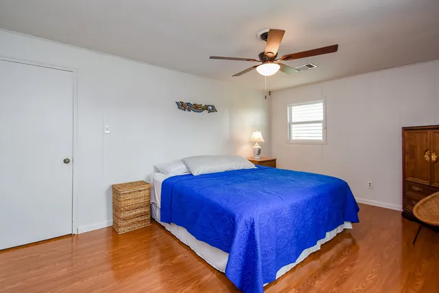 a bedroom with two beds and a window