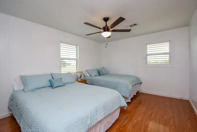a bedroom with a bed and a ceiling fan