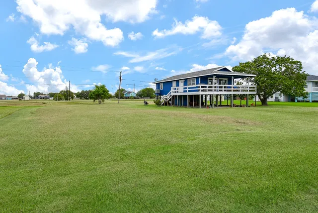 a view of a big house with a big yard