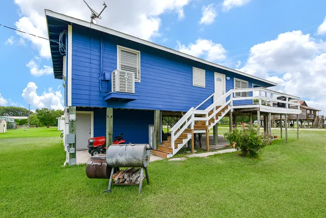 a view of a brick house with a yard