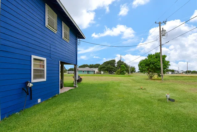 a view of a big room with a big yard and a large tree