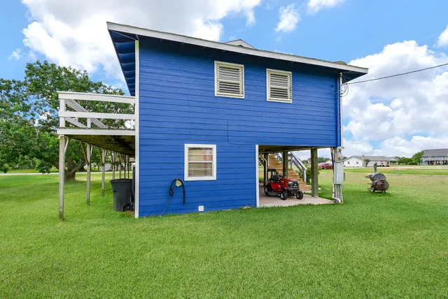 a view of yard with swimming pool and green space