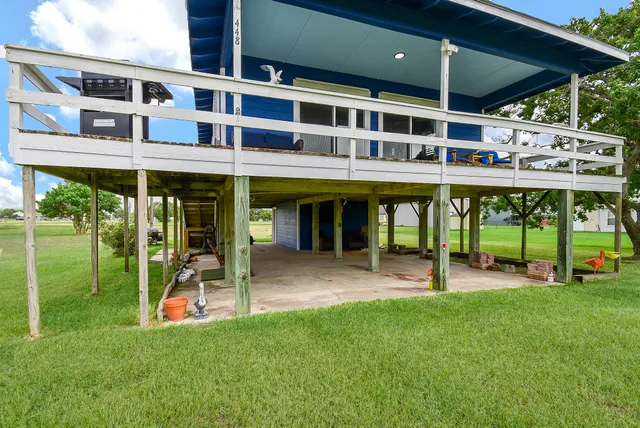 a view of a house with a yard and sitting area
