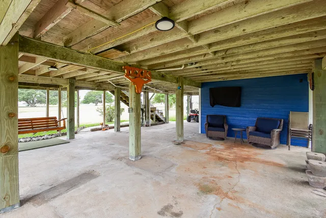 a view of an empty room with a fireplace and a window