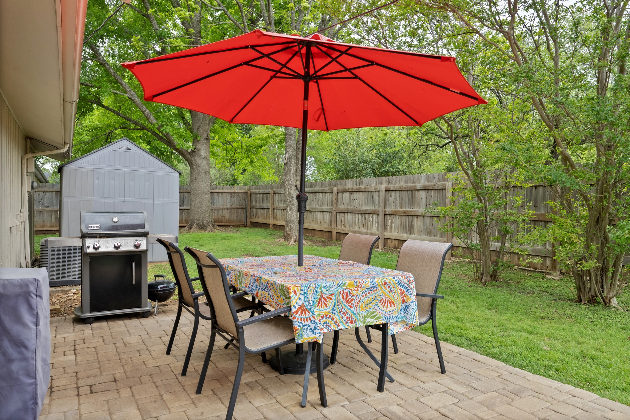 509 East 17th Street Georgetown, TX 78626 - Photo 24 of 40 Step outside to enjoy the stone paver patio, along with a storage shed and even a playground, creating a backyard space that’s both functional and enjoyable