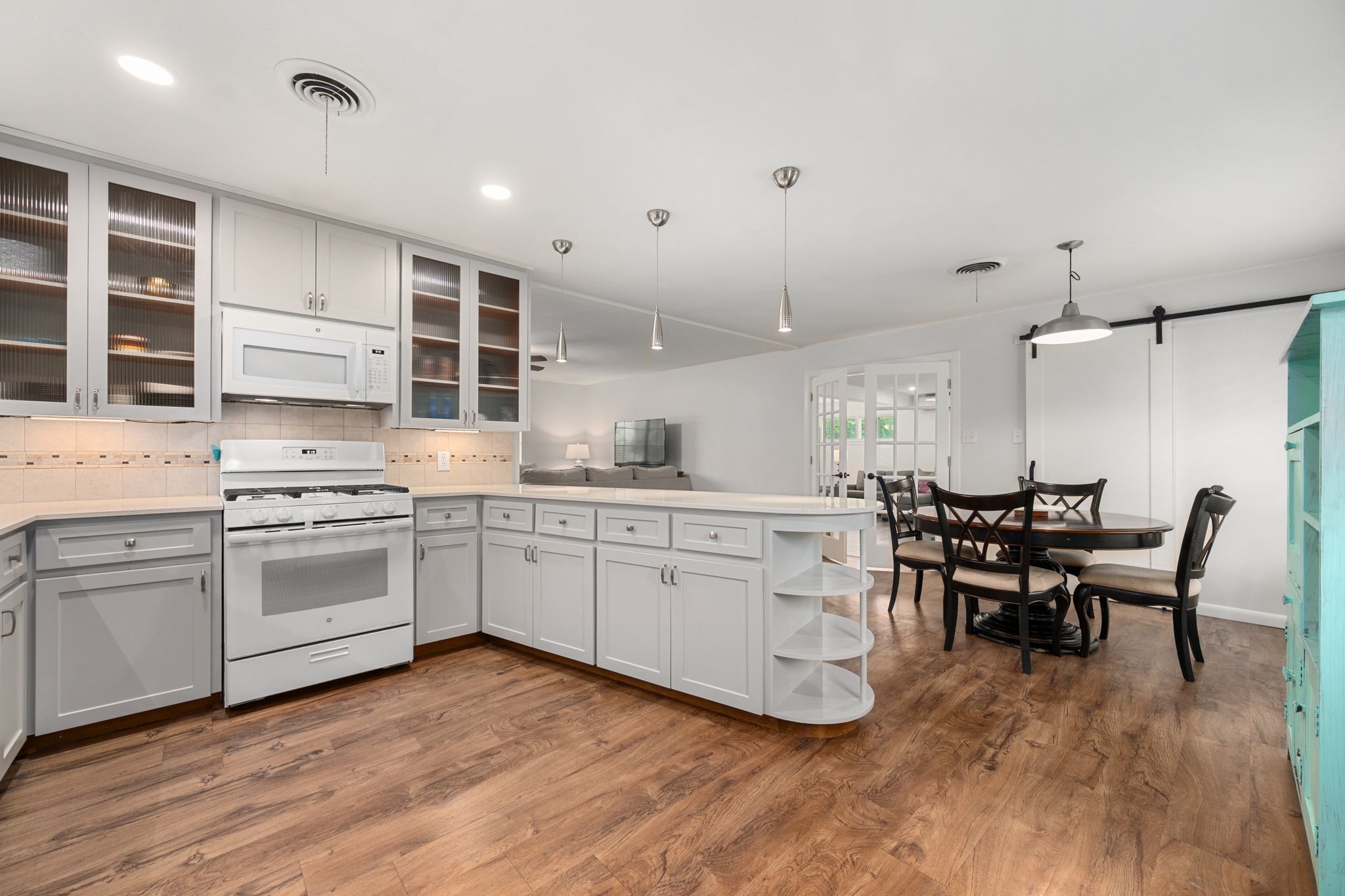 509 East 17th Street Georgetown, TX 78626 - Photo 5 of 40 Kitchen is open to the breakfast area. Behind the barn doors you'll find the laundry room, pantry and storage
