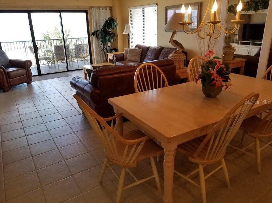 13650 Gulf Boulevard, Unit 304 Madeira Beach, FL 33708 - Photo 30 of 63 a view of a dining room with furniture and a large window