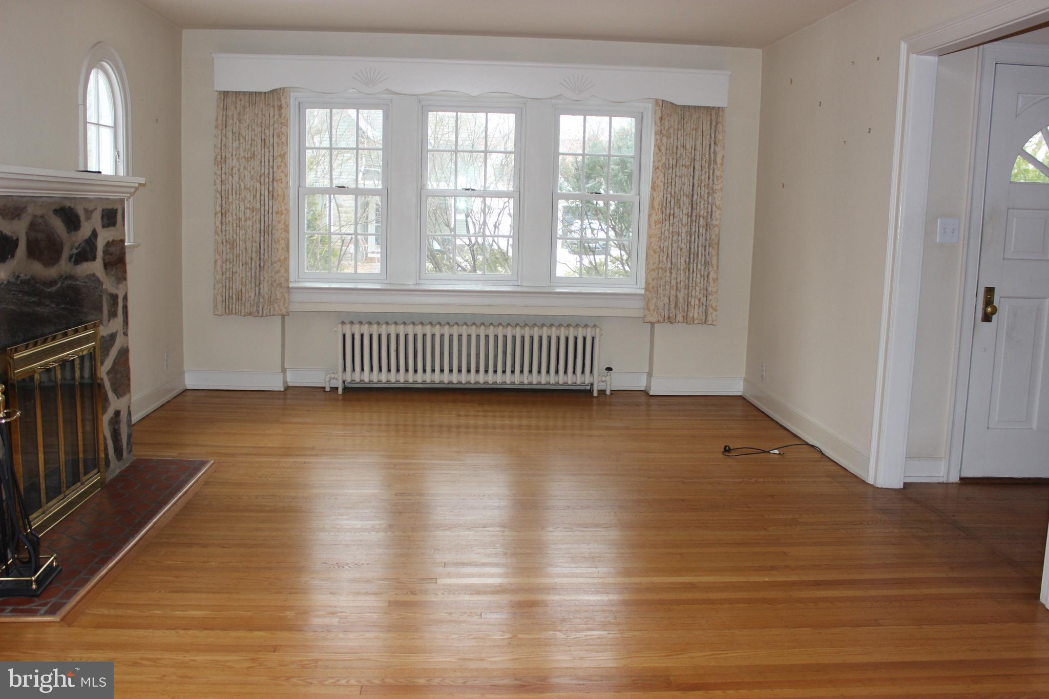 534 Kenwood Road Drexel Hill, PA 19026 - Photo 4 of 28 an empty room with wooden floor and windows