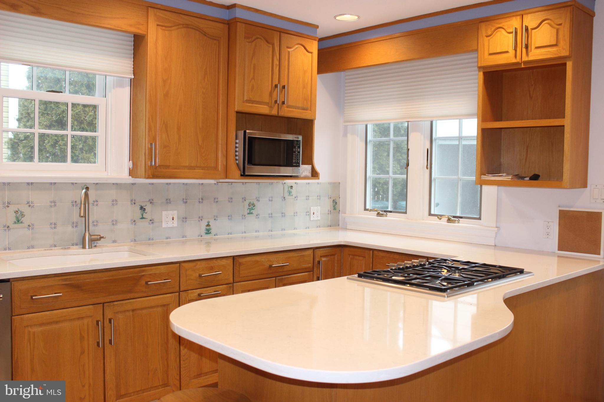 534 Kenwood Road Drexel Hill, PA 19026 - Photo 8 of 28 a kitchen with a sink stove and cabinets