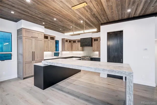 a large kitchen with stainless steel appliances kitchen island granite countertop a large counter top