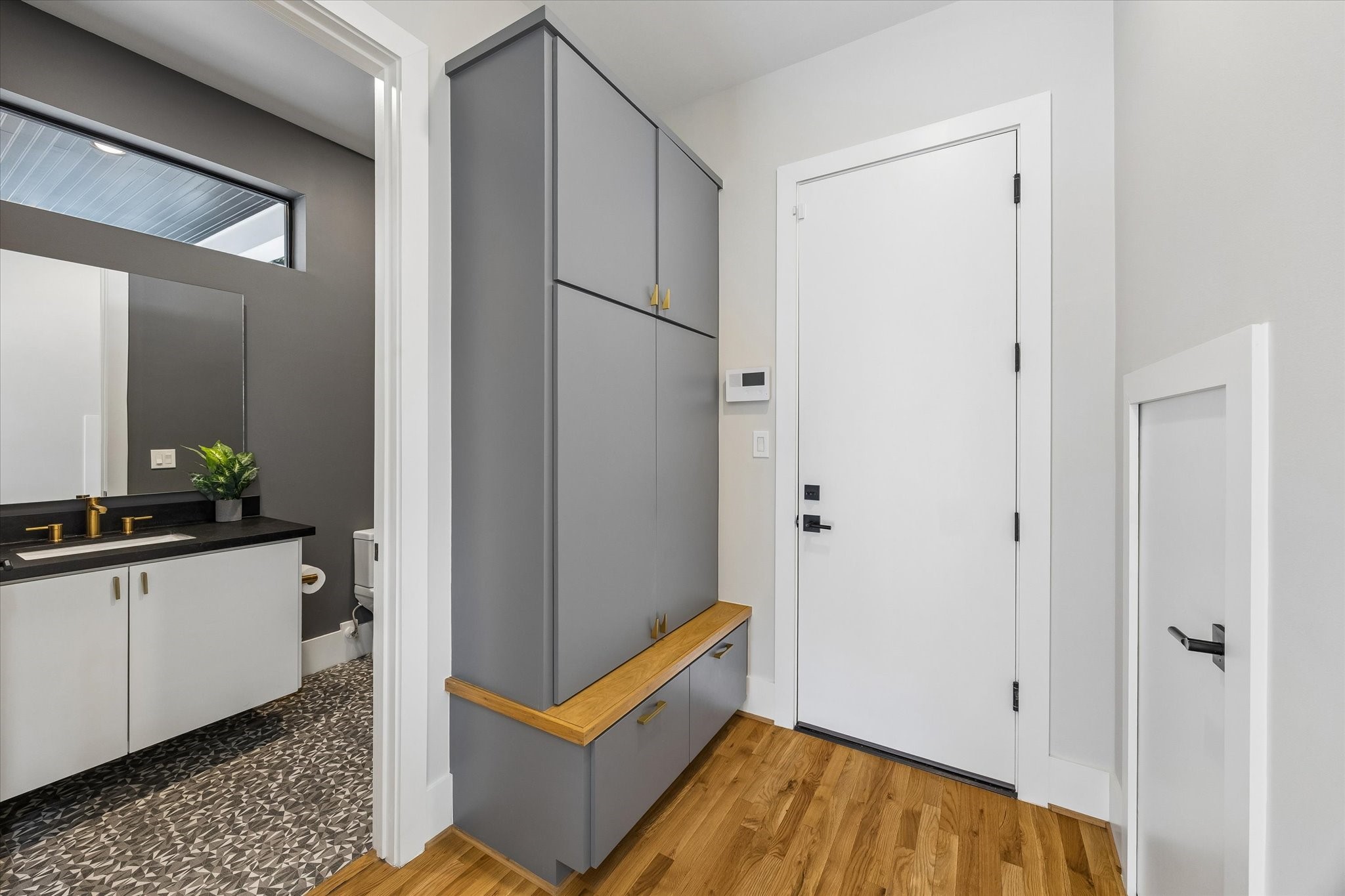 2705 Julian Street Houston, TX 77009 - Photo 21 of 50 Custom mud closet off of the garage door entrance as well as a half bath and extra (and deep) storage under the stairs.