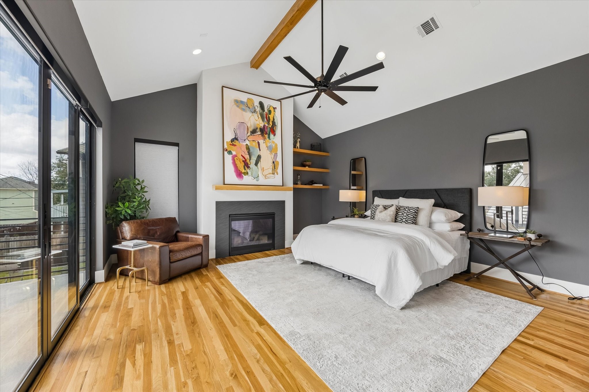 2705 Julian Street Houston, TX 77009 - Photo 23 of 50 This primary suite is an oasis with cathedral ceilings, a fireplace, large sliders providing natural light and custom paint.