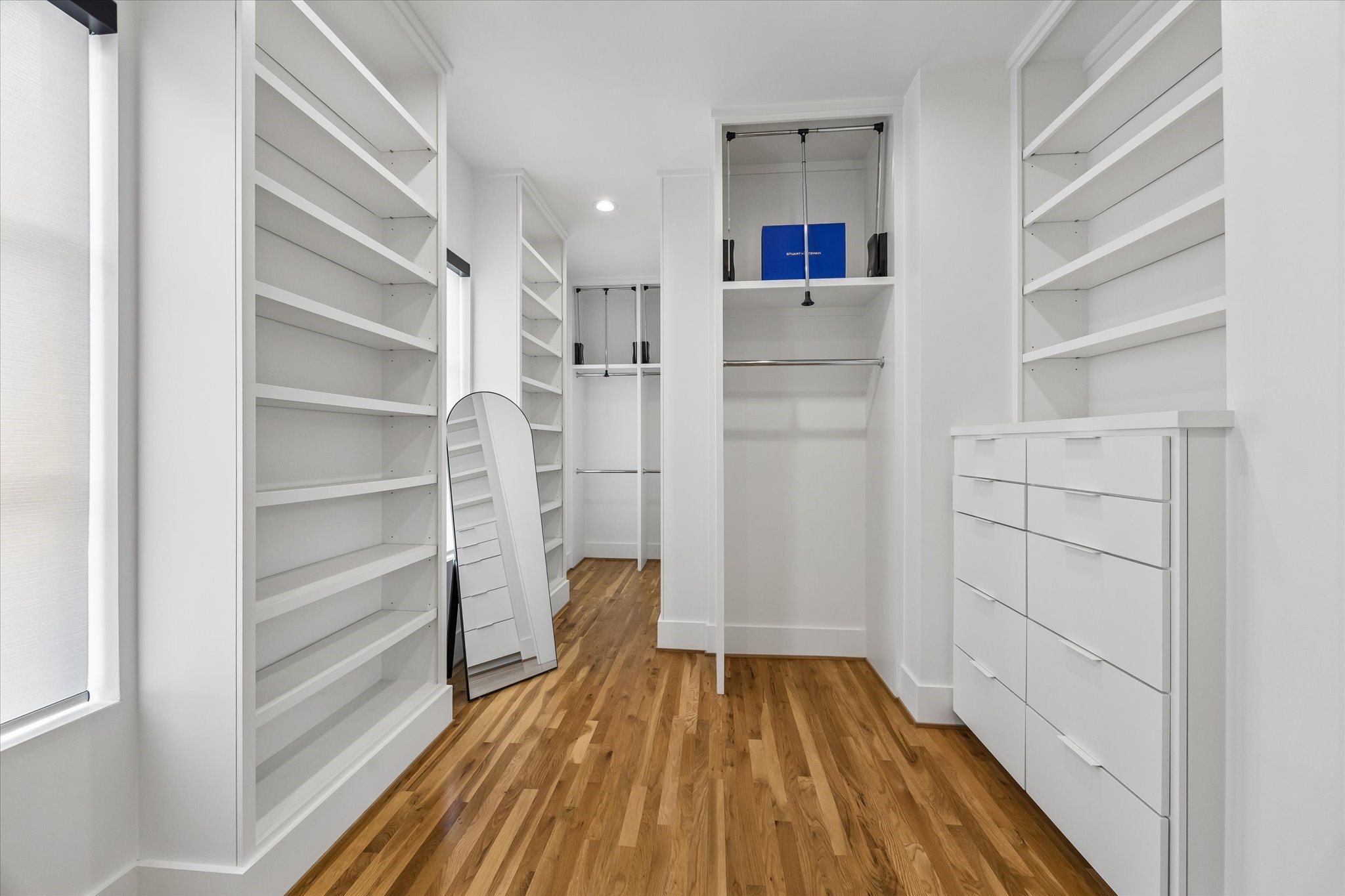 2705 Julian Street Houston, TX 77009 - Photo 29 of 50 Custom primary closet with built in drawers, lots of shelving for shoes and storage and triple racks for extra storage for clothes.
