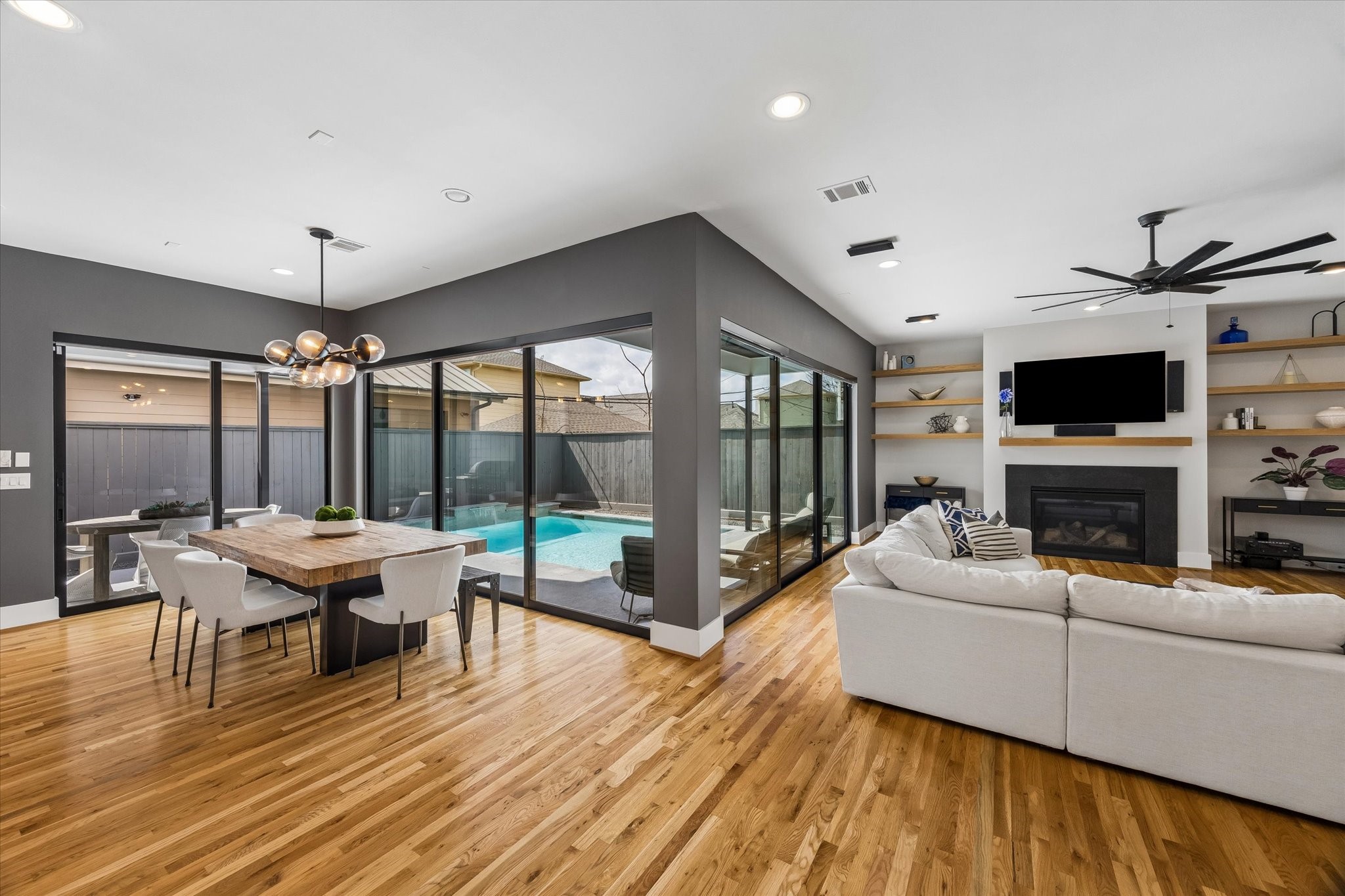 2705 Julian Street Houston, TX 77009 - Photo 7 of 50 3 walls of windows/sliders frame the living room/dinning room giving beautiful views of the pool.