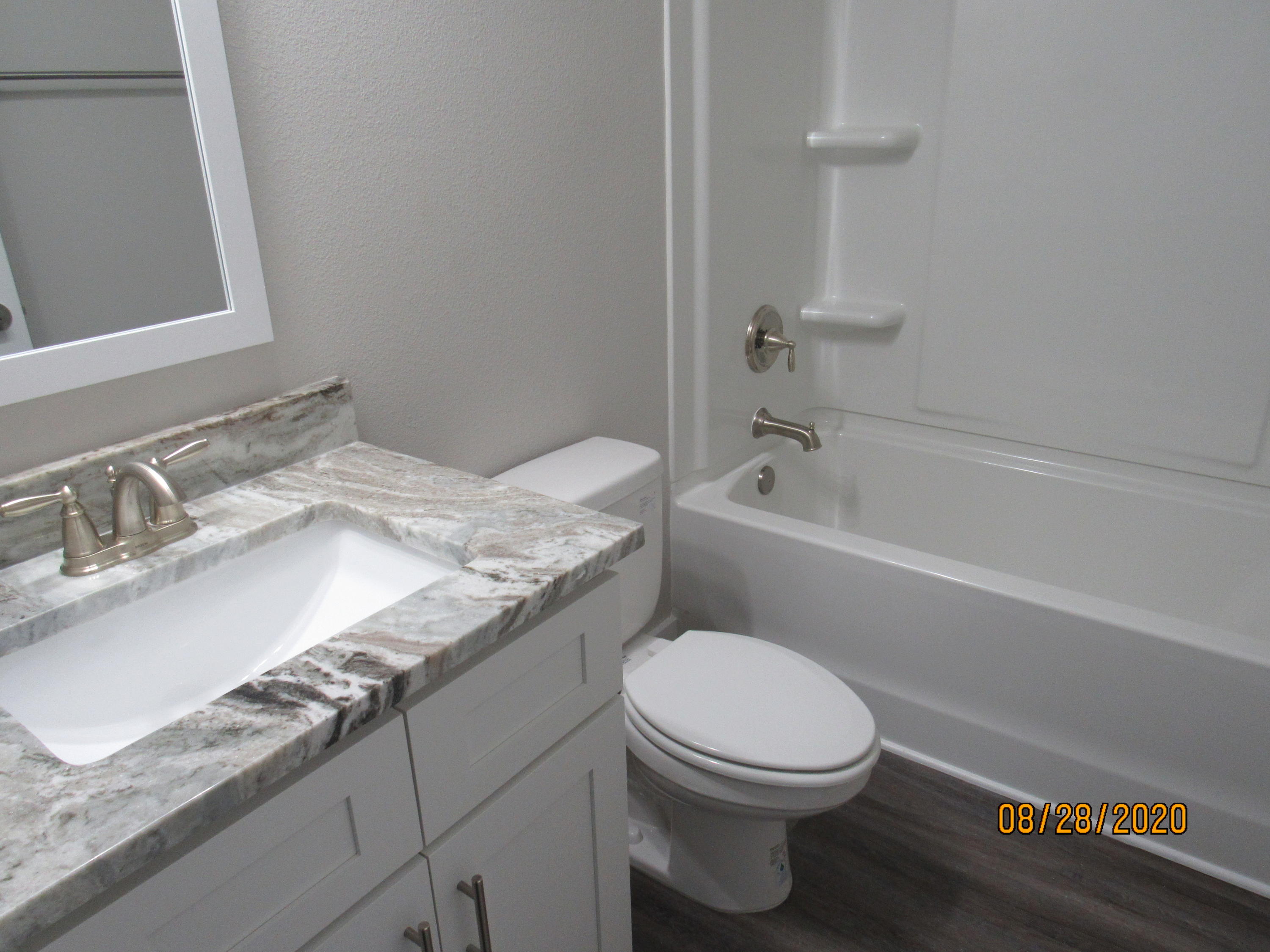 75 South Sand Palm Road Freeport, FL 32439 - Photo 14 of 18 a bathroom with a granite countertop toilet a sink and bathtub
