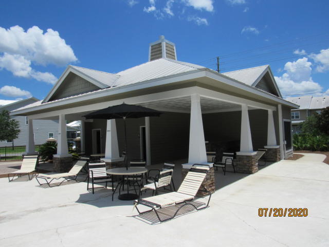 75 South Sand Palm Road Freeport, FL 32439 - Photo 18 of 18 a view of a patio with table and chairs a barbeque with wooden fence