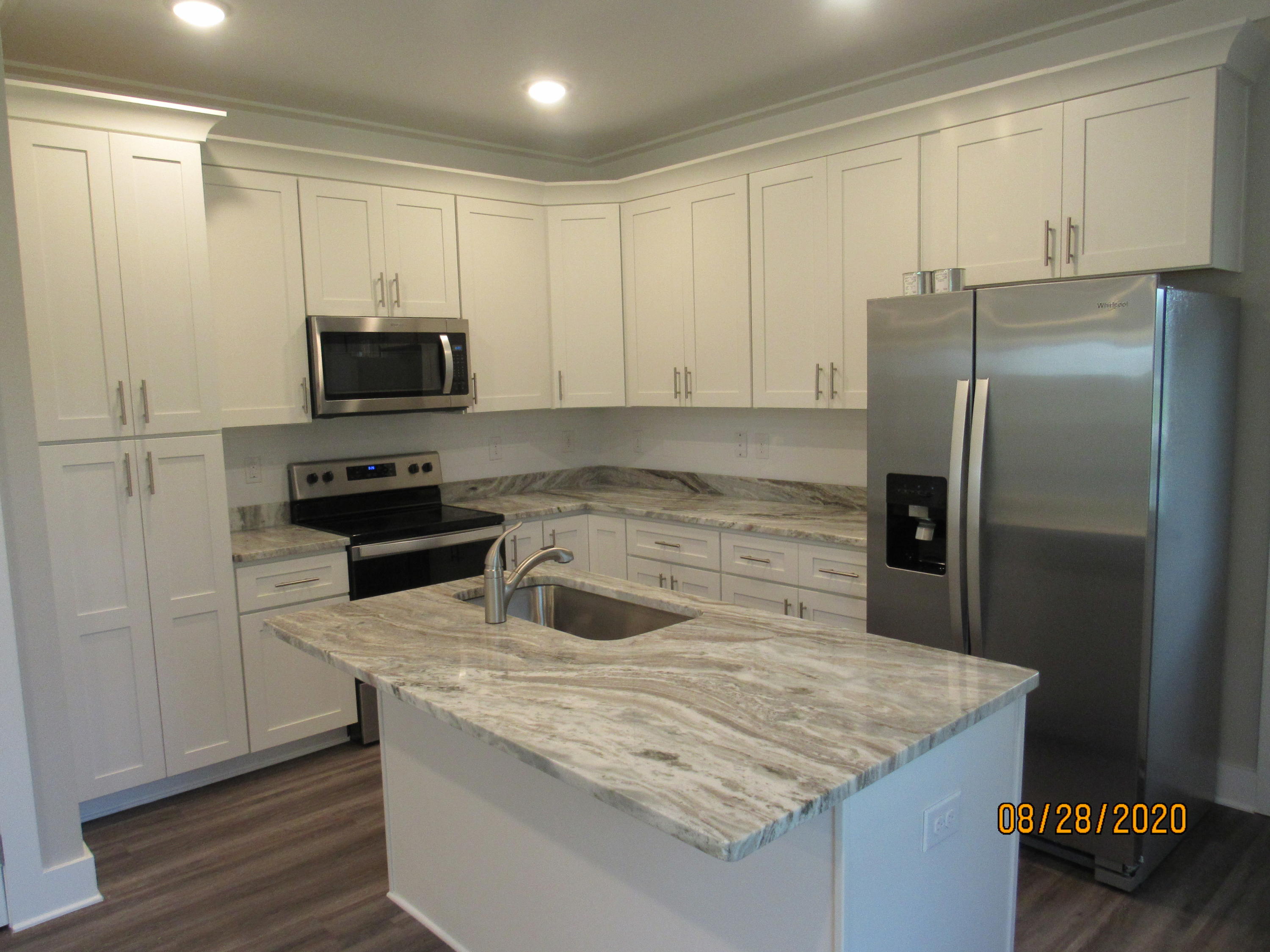 75 South Sand Palm Road Freeport, FL 32439 - Photo 2 of 18 a kitchen with kitchen island granite countertop a sink stove and refrigerator