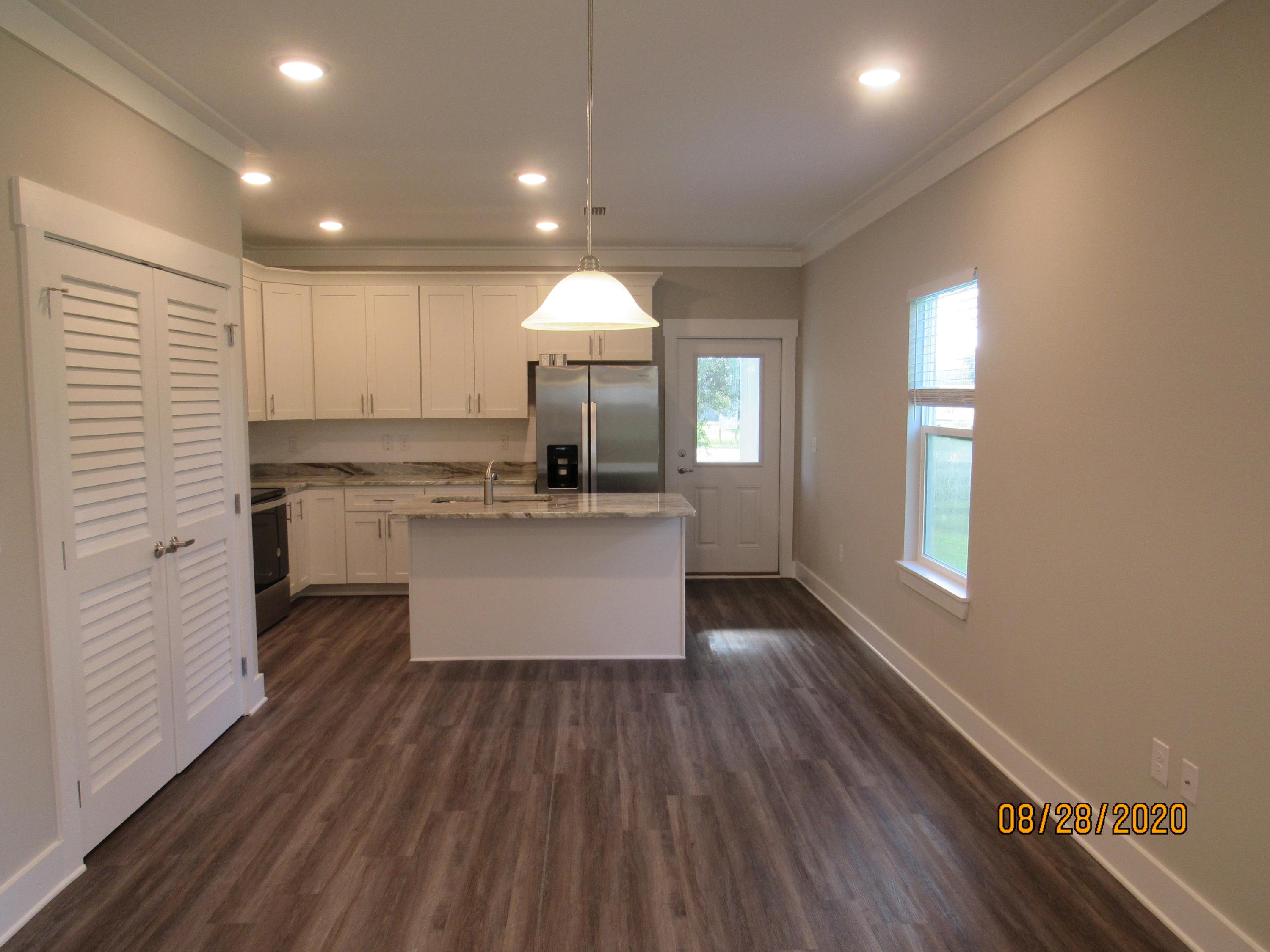 75 South Sand Palm Road Freeport, FL 32439 - Photo 3 of 18 a large kitchen with kitchen island white cabinets and stainless steel appliances