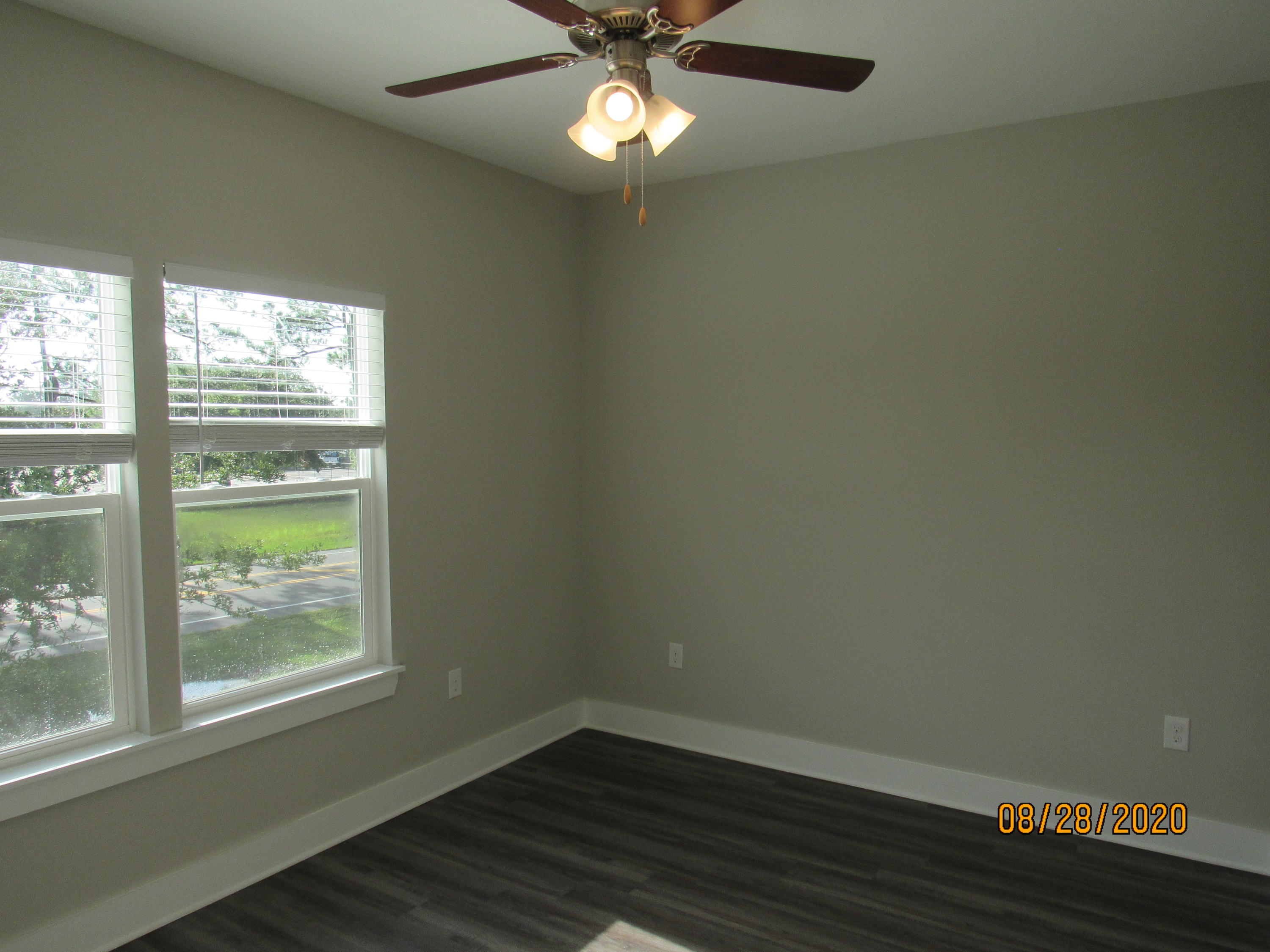 75 South Sand Palm Road Freeport, FL 32439 - Photo 9 of 18 an empty room with wooden floor and windows