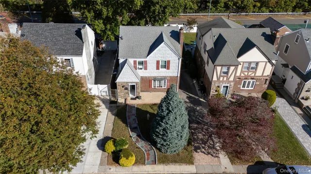 an aerial view of residential houses with yard