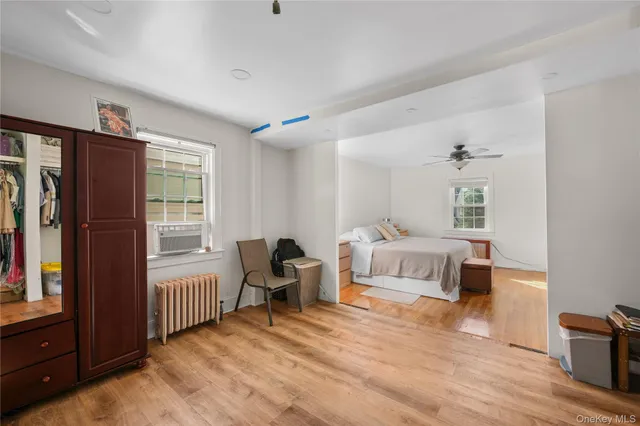 a bedroom with a bed and a ceiling fan
