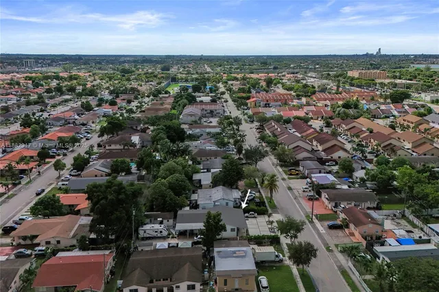 an aerial view of residential house with green space