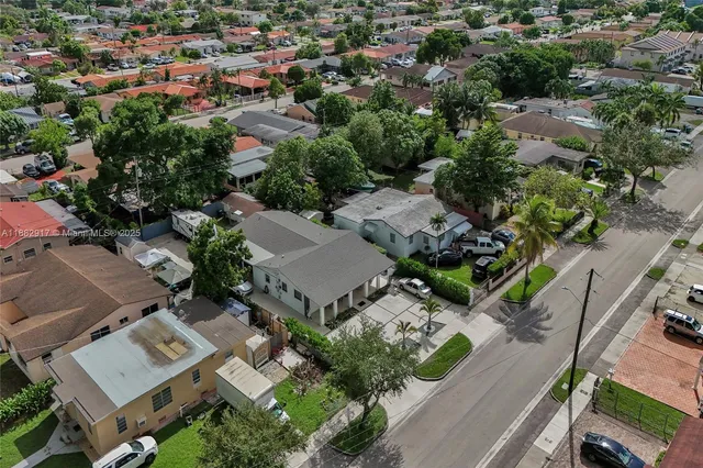 an aerial view of multiple houses with yard