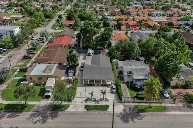 an aerial view of residential houses with city view
