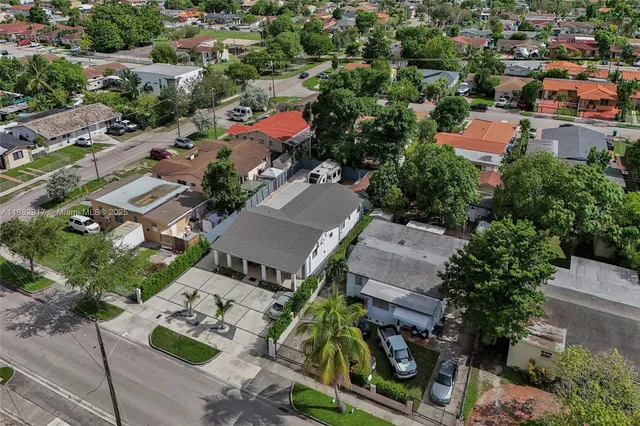 an aerial view of residential houses with outdoor space