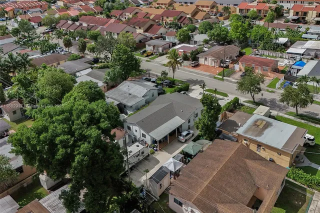 an aerial view of residential houses with outdoor space