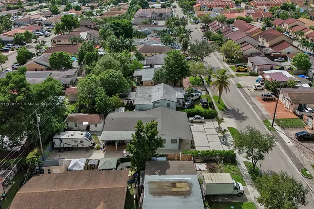 an aerial view of a house with a yard and lake view