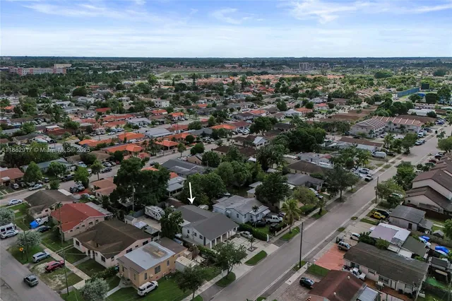 an aerial view of residential houses with city view
