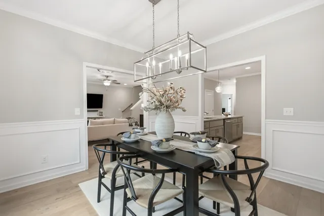 a view of a dining room with furniture and chandelier