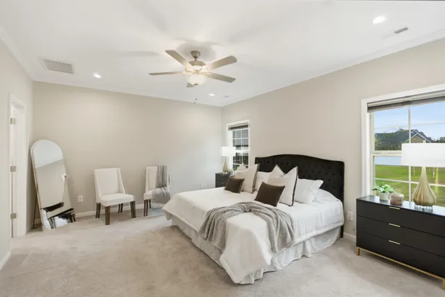 a bedroom with a bed window and table