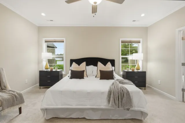 a large bed sitting in a bedroom next to a window