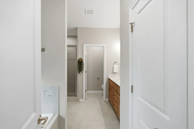 a bathroom with a bathtub and a double vanity sink