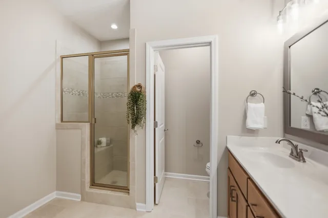 a bathroom with a double vanity sink mirror and shower