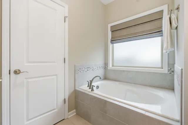 a white bath tub sitting next to a window