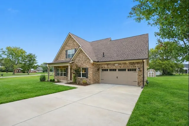a front view of house with yard and green space