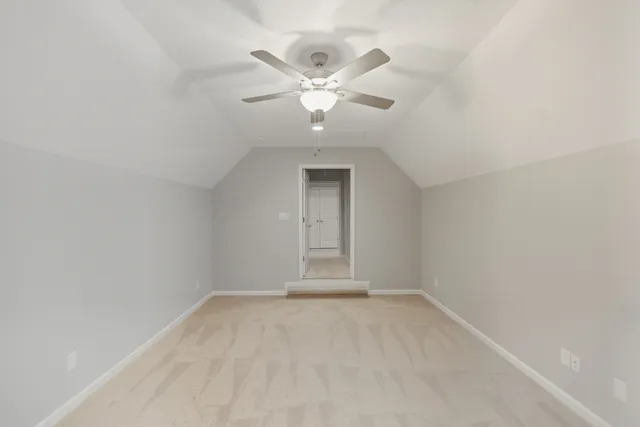 an empty room with a window and a ceiling fan