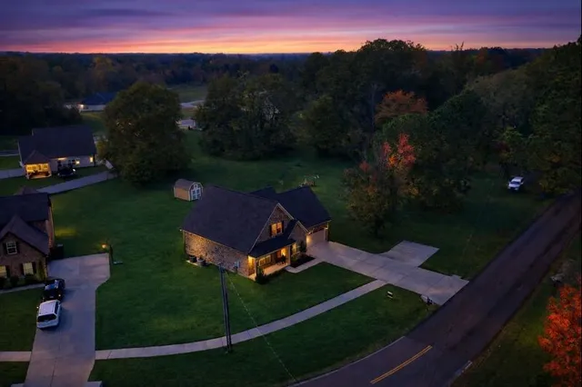 an aerial view of a house with garden space and street view