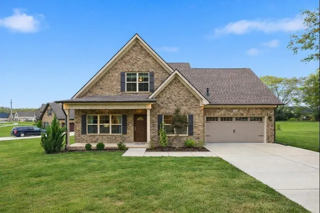 a front view of a house with a yard