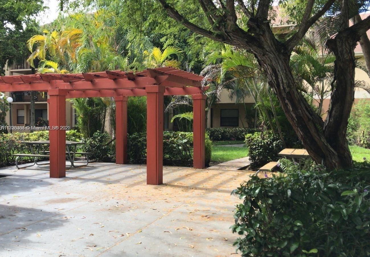 a view of a house with a tree in front of it