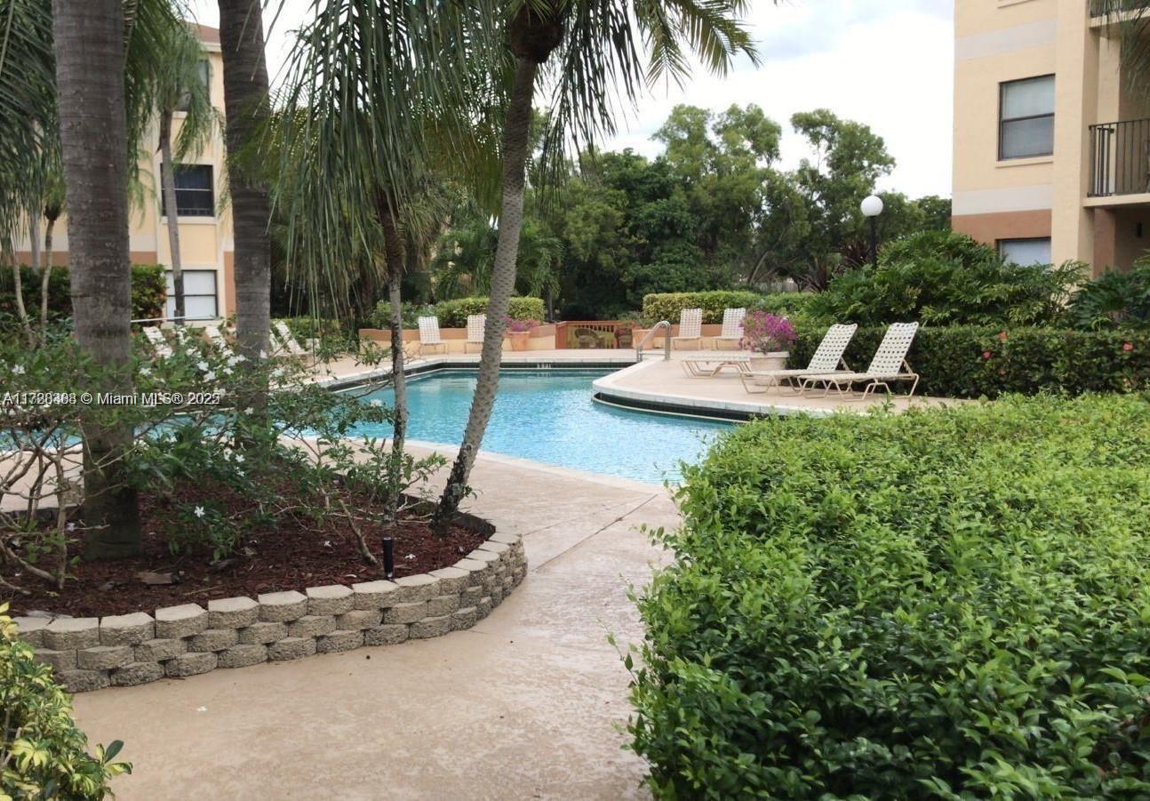 Summerbreeze Condominiums Sunrise, FL 33322 - Photo 2 of 12 a view of a fountain in the yard of a house
