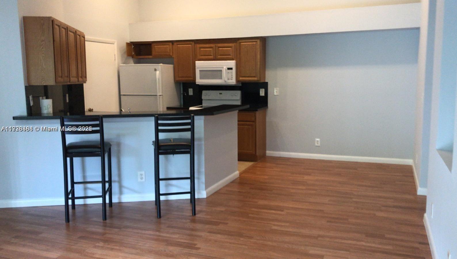 Summerbreeze Condominiums Sunrise, FL 33322 - Photo 5 of 12 a kitchen with stainless steel appliances a refrigerator and stove